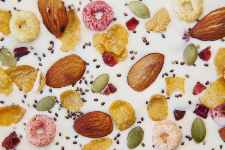 A top view of cereal in milk with almonds, seeds, and berries.